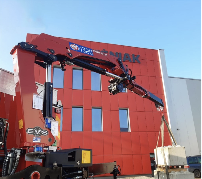 medium loading crane in front of building